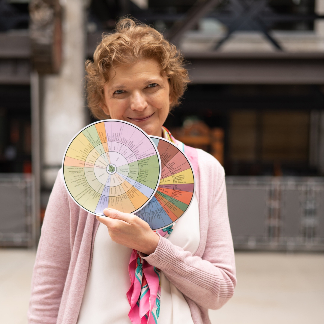 Isabelle Lesschaeve is featured in this photo holding the wine aroma wheel duo.